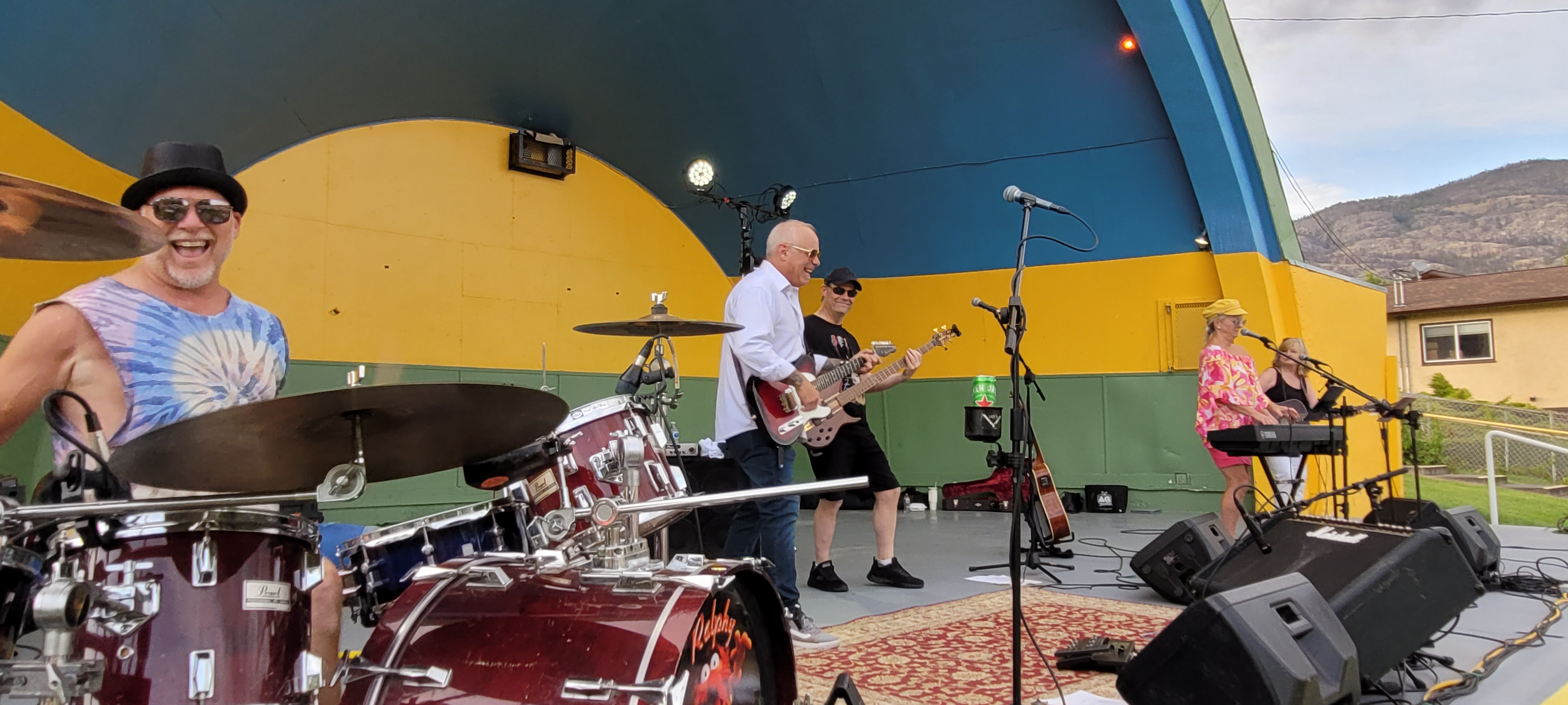 Live musical performance on an outdoor community bandshell stage